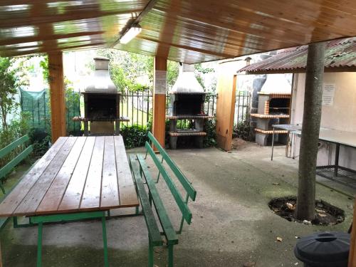 a picnic table and a bench in a patio at Bungalows & Albergue La Playa in Logroño