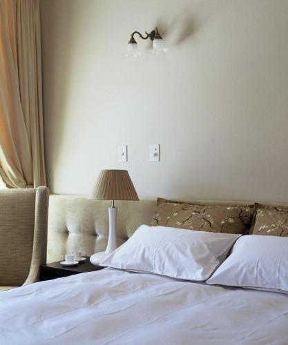 a bedroom with a bed and a lamp on a table at Banksia Boutique Hotel & Spa in Cape Town