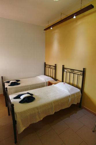 a room with two beds in a room at Oikeion in Ermoupoli
