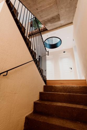 a staircase in a building with a round window at Palacio Condes de Cirac in Villalba de Rioja