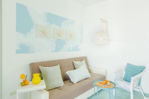 a living room with a couch and a chair at Casa Rosa a 50mt dal mare in Torre Santa Sabina