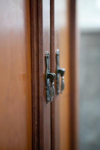 a close up of a wooden door with metal knobs at Banksia Boutique Hotel & Spa in Cape Town