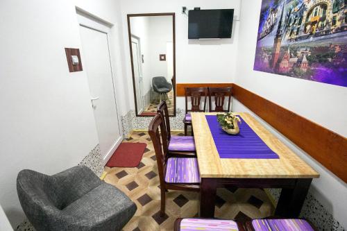 a dining room with a table and a chair at Hostel Put Svile in Subotica