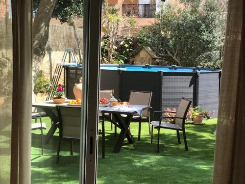 a patio with a table and chairs on the grass at Ca Na Clar in Sa Ràpita