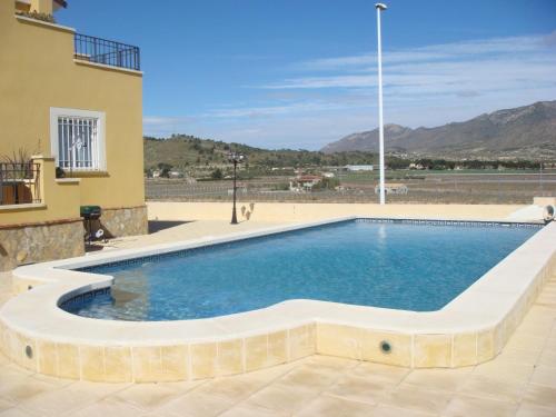 a swimming pool in the middle of a building at Hondon-Villa in Hondón de las Nieves