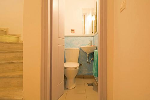 a bathroom with a toilet and a sink at VILLA AELIA in Spetses - charm & convenience, 2min beach in Spetses