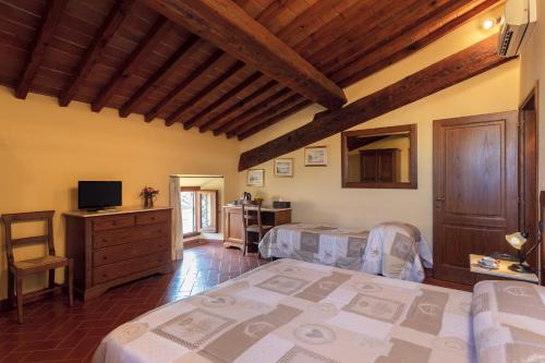 a bedroom with two beds and a television in it at Palazzo Graziani in Florence