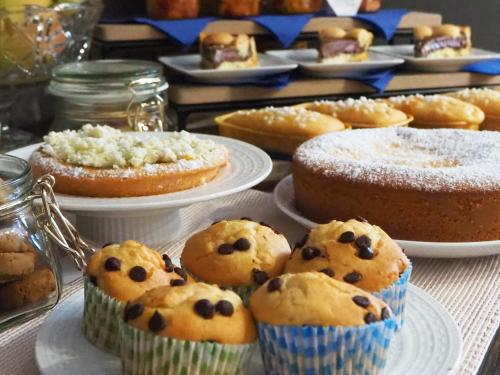a table topped with cakes and pies on plates at Albergo Diffuso Sotto le Cummerse in Locorotondo