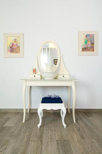 a white dressing table with a mirror and a stool at VILLA AELIA in Spetses - charm & convenience, 2min beach in Spetses