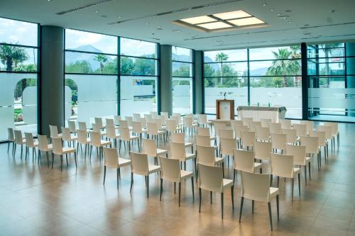 a room with rows of chairs and a podium at Hotel Deloix 4* Sup in Benidorm
