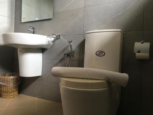 a bathroom with a toilet and a sink at Pick & Go White House in Negombo