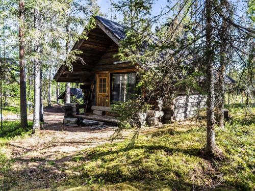 eine Blockhütte im Wald mit Bäumen in der Unterkunft Holiday Home Tievatupa 2- pienempi by Interhome in Ylläsjärvi