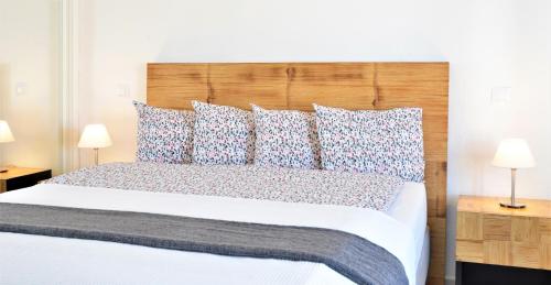 a bedroom with a large bed with blue and white pillows at Casa La Vista - Bungalow with fantastic sea views in Arguineguín
