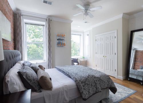 a bedroom with a bed and a ceiling fan at Your Home Away For Home, Convention Center. 96 WALK SCORES. in Washington, D.C.