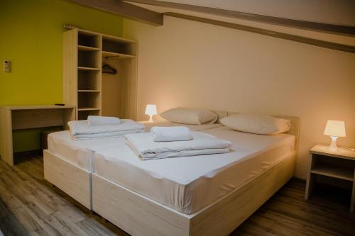 a bedroom with two beds with white towels on them at Pansion Fočin Han in Sarajevo