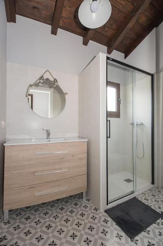a bathroom with a shower and a sink and a mirror at Villa El tinganon in Llanes