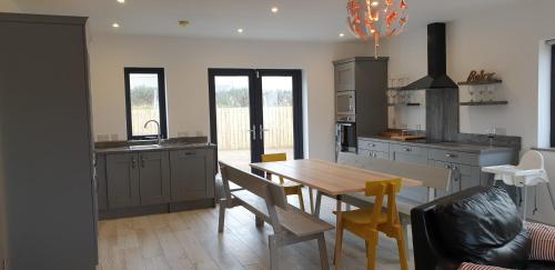 a kitchen with a table and a dining room at No 5 sandycove in Donegal