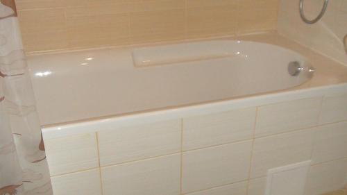 a white bath tub sitting in a bathroom at Borovets Gardens Studio D36 in Borovets