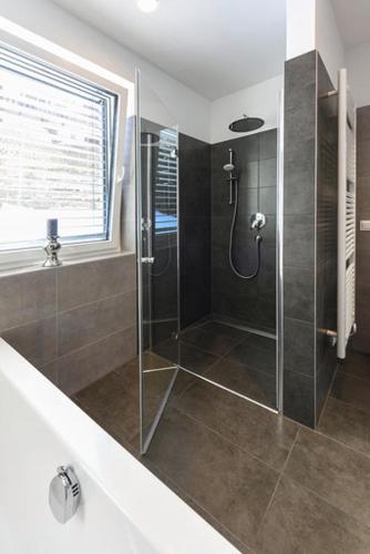 a bathroom with a shower with a glass door at Seechalet in Altossiach