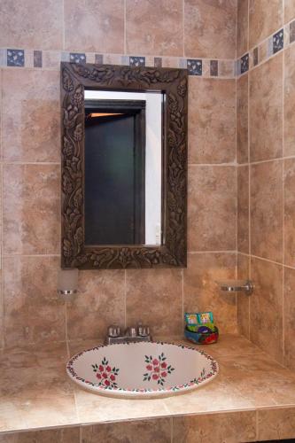 a bathroom with a sink and a mirror at Posada Maria Luisa in San Miguel de Allende