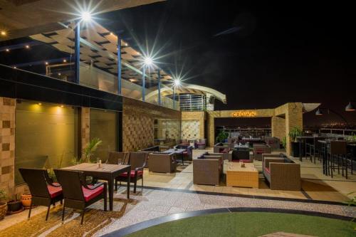 a restaurant with tables and chairs at night at Souvenir Jaipur in Jaipur