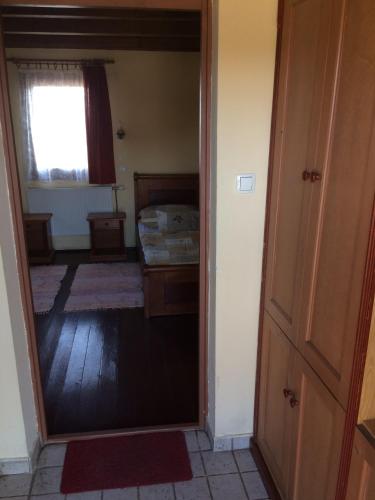 a room with a bedroom with a bed and a window at Convoy Panzió in Szajol