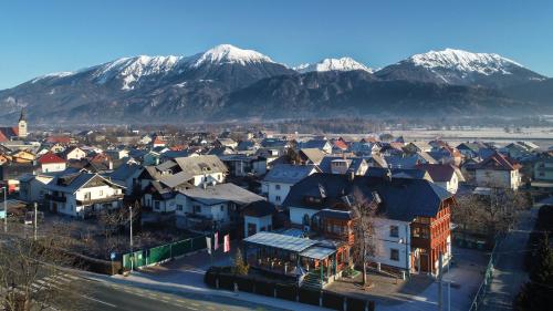 a town with houses and mountains in the background at Guesthouse Tulipan in Lesce