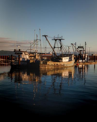 two boats docked at a dock in the water at Norblad Hotel in Astoria, Oregon