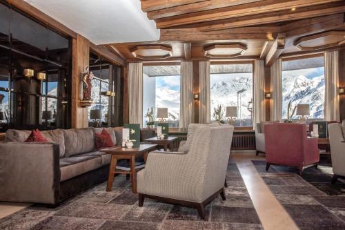a living room with a couch and a table at Hotel Edelweiss Hochsölden Superior in Sölden