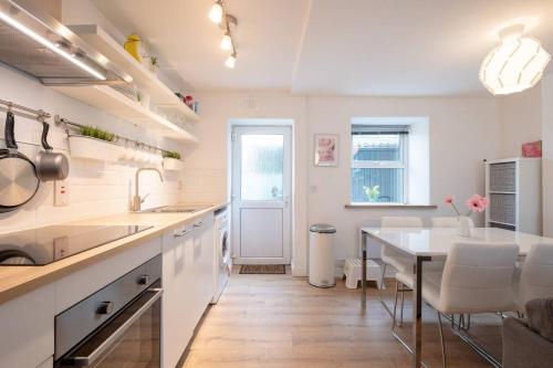 a kitchen with a table and a dining room at Galway City Cottage in Galway
