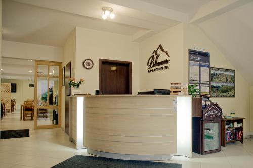 a lobby of a pharmacy with a reception counter at Aparthotel Bellamonte in Zakopane