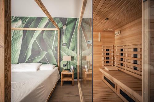 a bedroom with a canopy bed and a desk at Hotel San Giacomo Spa&Gourmet in Brentonico