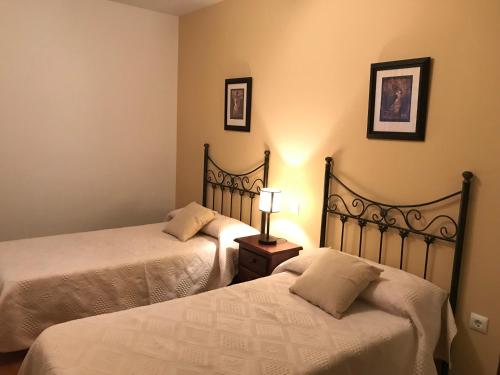 two beds sitting next to each other in a room at CASA RURAL LA IBIENZA in Zarzuela del Pinar
