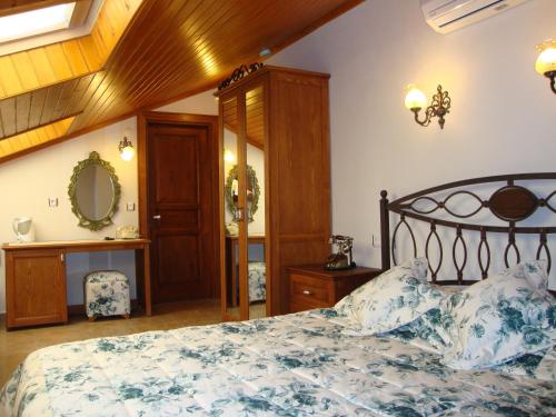 a bedroom with a bed and a dresser and a mirror at Konak Tuncel Efe in Datca