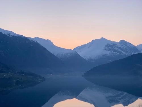 a view of a lake with snow capped mountains at Olden Fjord Apartments in Olden