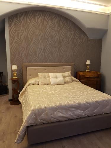 a bedroom with a large bed with a wall at Hotel Sangiuliano 132 centro storico Catania in Catania