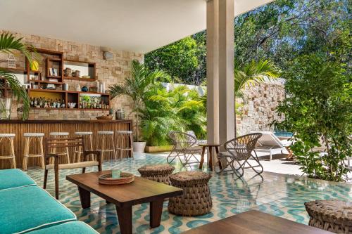 a living room with a couch and a bar at Hotel Tiki Tiki Tulum in Tulum