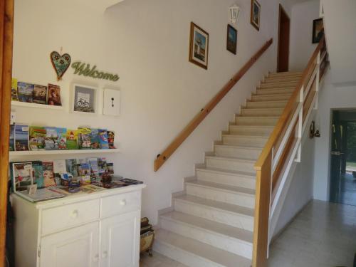 a staircase in a living room with a stair case at Appartement Landhaus Felsenkeller in Sankt Kanzian