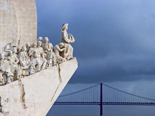 a statue of a group of people on a bridge at Hotel ibis Lisboa Jose Malhoa in Lisbon