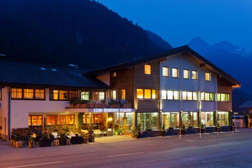 a hotel with a building in the middle of a street at Boutiquehotel Grandau in Sankt Gallenkirch