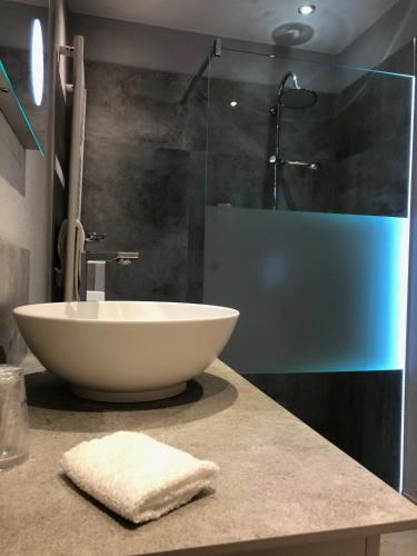a bathroom with a sink and a glass shower at Hotel-Restaurant Barbarossahof in Kaiserslautern