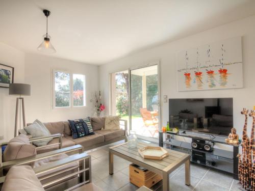 a living room with a couch and a tv at Holiday Home La Plage by Interhome in Labenne