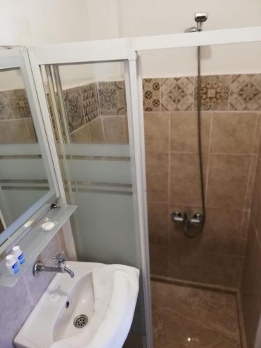 a bathroom with a sink and a shower at Urkmez Hotel in Selcuk