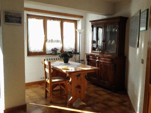 a dining room with a wooden table and a cabinet at Hotel Villa Stella in Cascia