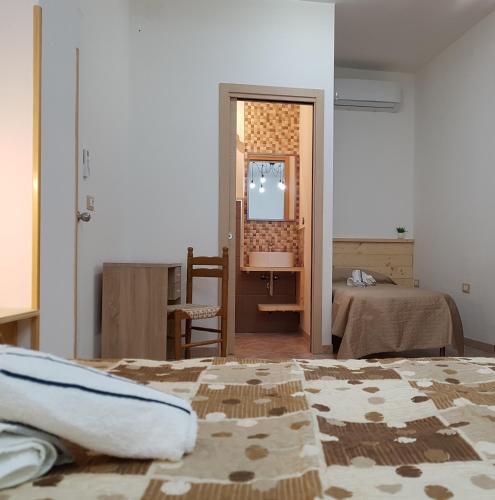 a bedroom with two beds and a mirror and a mirror at B&B Casa Alessandro in Scalea