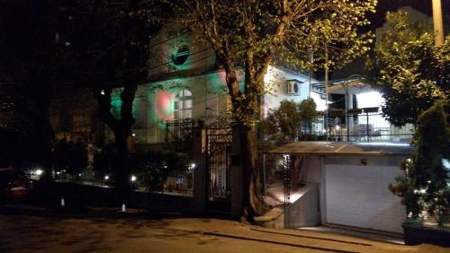 a house with a gate in front of it at night at Resident hill resort in Belgrade