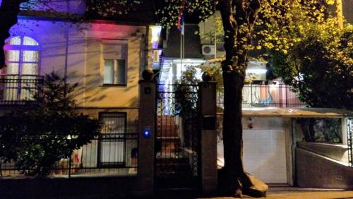 a house with a fence and a garage at night at Resident hill resort in Belgrade