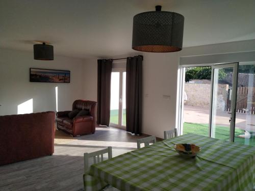 a living room with a table with a green and white checkered table cloth at Casa da Tia Dulce in Pataias