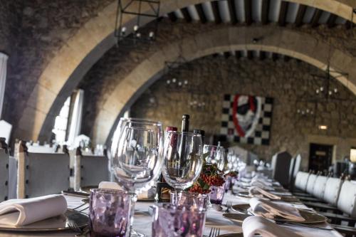 a long table with wine glasses and napkins on it at Parador de Siguenza in Sigüenza