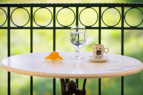 a table with a glass of water and a cup at Koronisia Apartments in Koronisia